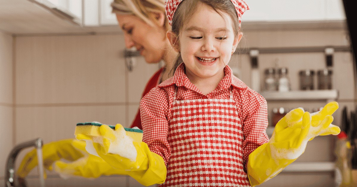 little girl washing plates