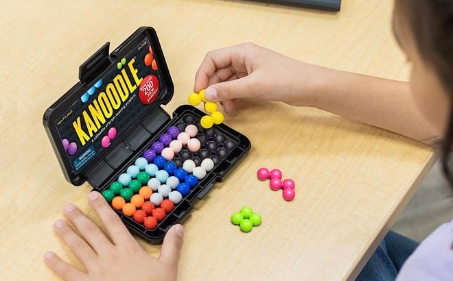 Baby girl playing kanoodle