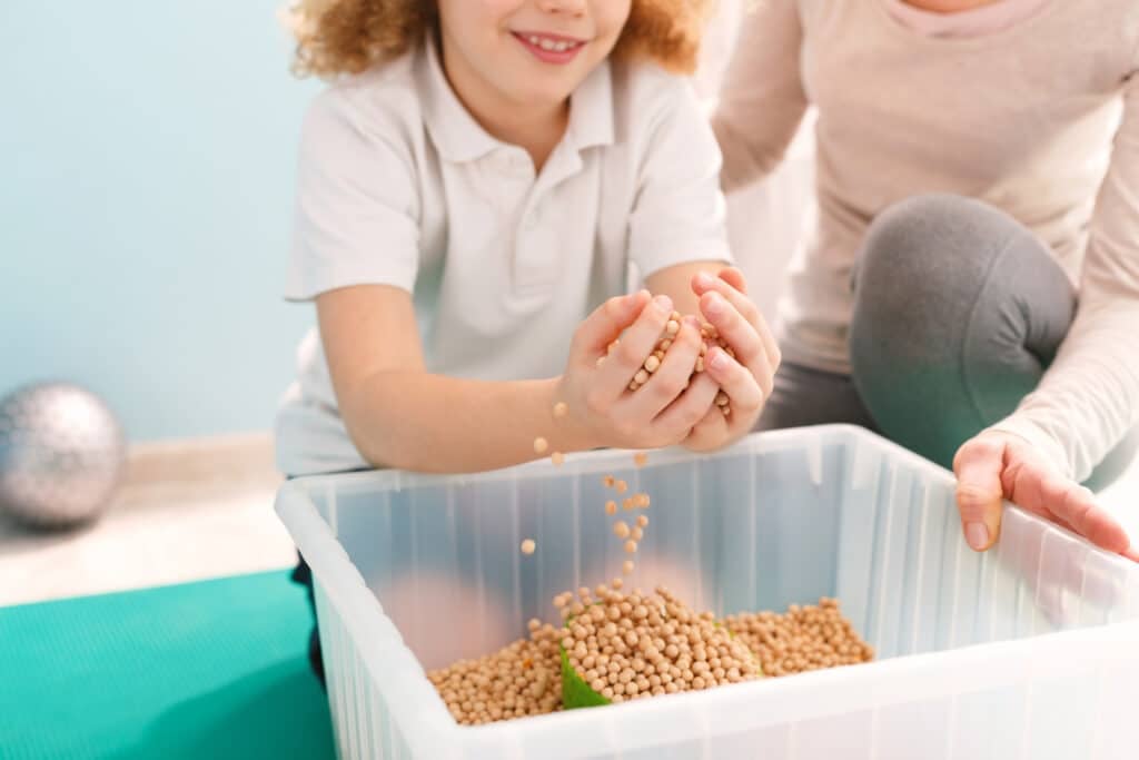 Toddler playing Sensory Bins