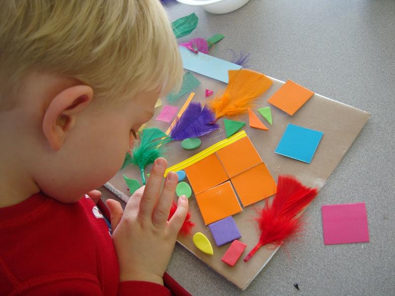 Child creating colorful collages